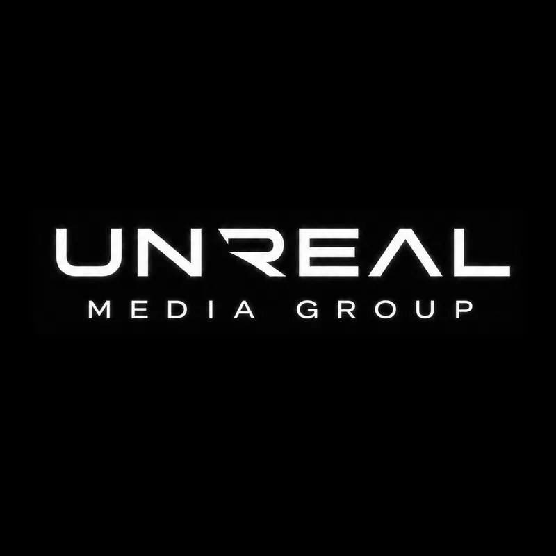 Unreal Media Group primary lockup in white for dark backgrounds